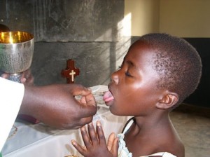 African-Boy-receiving-Communion